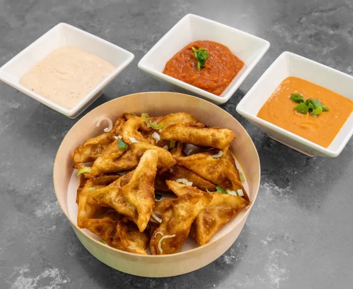 Golden fried momo with three dipping sauces