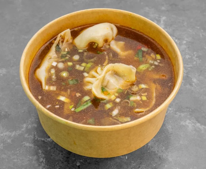 Momo in a spiced broth with spring onions
